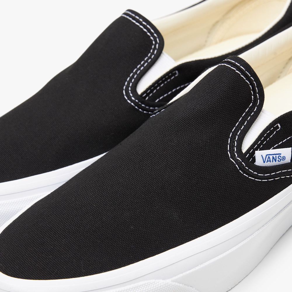 Black white vans slip ons top